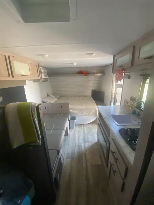 Compact rv rental interior with bed, dinette, kitchen, and ample storage for travel comfort.. Coleman Lantern LT 17b 2024