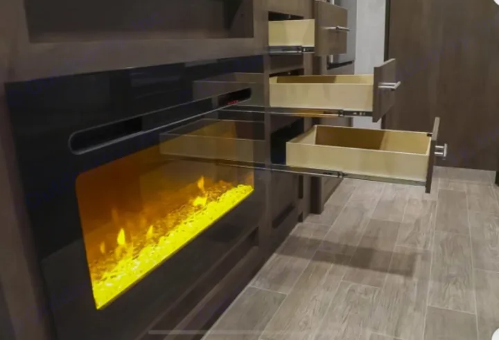 Cozy RV rental interior featuring a modern electric fireplace with vibrant flames and several open storage drawers.. Dutchmen Coleman Lantern 2021
