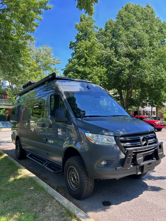 A "NORVA" dark gray Mercedes Sprinter camper van, equipped for RV rental adventures, parked on a sunny street.. Mercedes sprinter 2500 170 AWD 2024