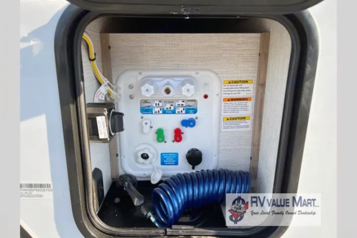 RV rental utility bay with comprehensive water hookups, control panel, and battery disconnect switch for user convenience.. Forest River Palomino Solaire 2023