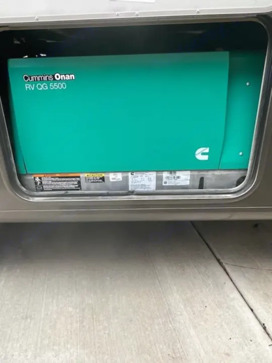 A Cummins Onan RV QG 5500 generator, essential for any RV rental, providing onboard power for travel.. Forest River Coachmen Pursuit 2017