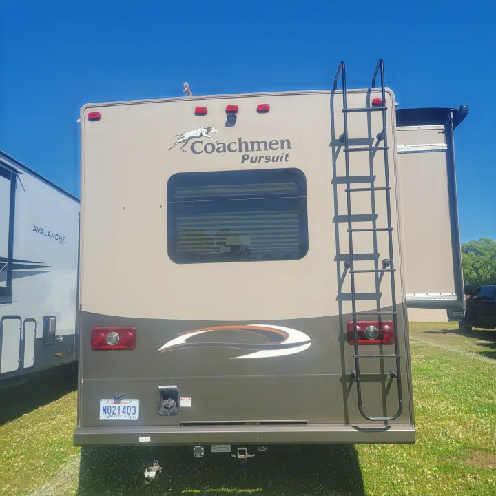 Back of a Coachmen Pursuit RV rental, featuring a ladder, rear window, and LA plate, for your road trip.. Forest River Coachmen Pursuit 2017