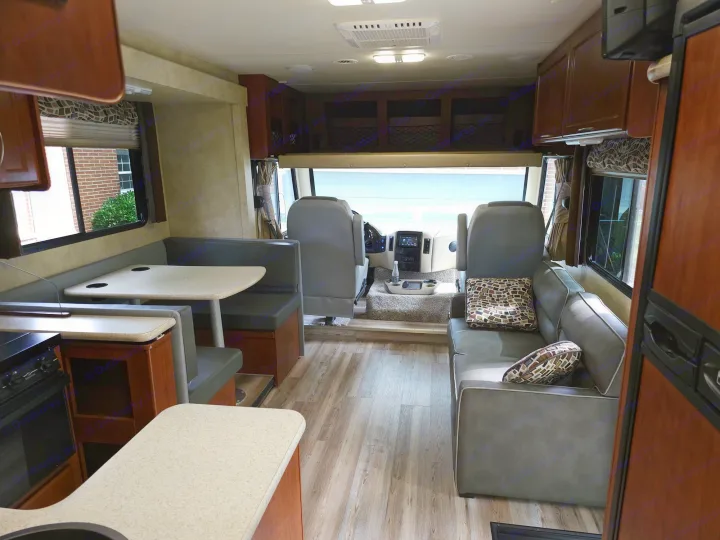 RV rental interior: a bright, modern living space featuring a dinette, sofa, and kitchen, perfect for travel.. Thor 29.1 2012