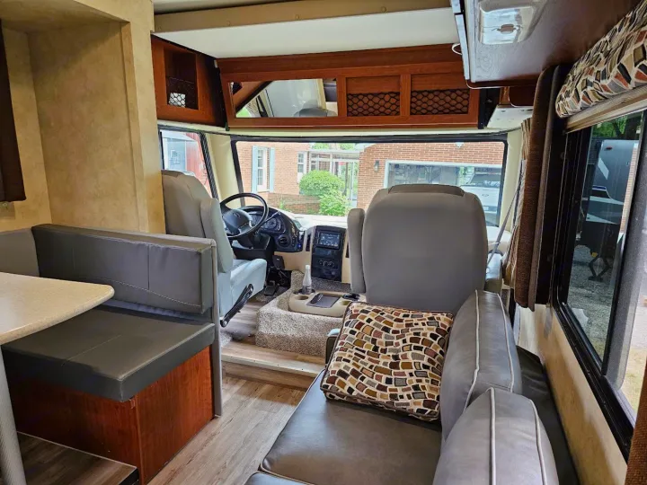 Inside a comfortable **rv rental**: front cockpit, dinette booth, and sofa seating for travel comfort.. Thor 29.1 2012