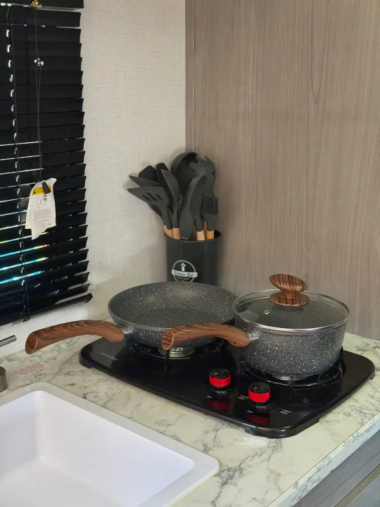 RV rental kitchen: stovetop, sink, pots, pans, and utensils for easy cooking in a compact space.. Coleman Lantern 17B 2024