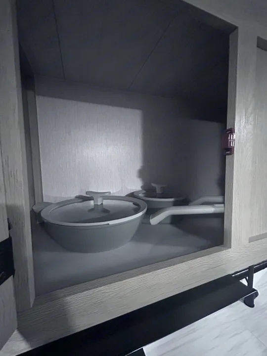 Essential kitchenware: light grey cooking pots neatly stored in this RV rental cabinet.. Forest River Salem Cruise Lite 2024