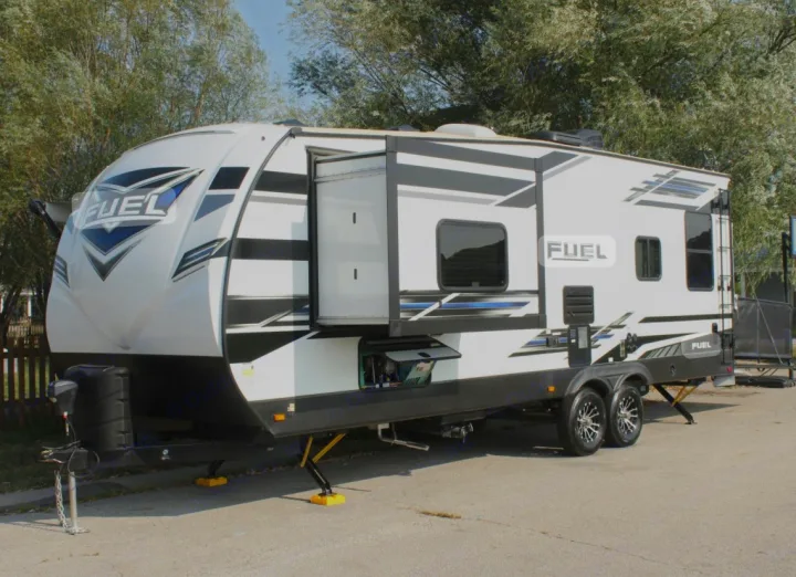 This sleek white Fuel toy hauler RV rental features blue/black graphics & an extended slide-out.. Heartland RVs Fuel Toy Hauler 2021