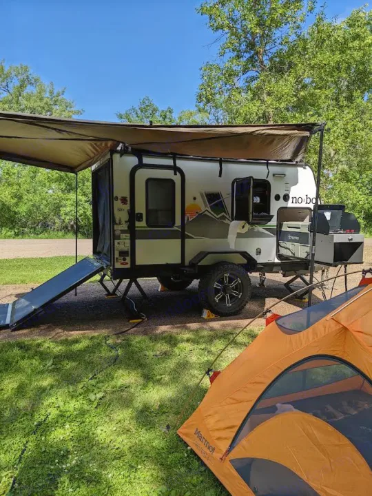 Outdoor adventure with a compact RV rental & tent setup. Ideal for camping enthusiasts seeking portable comfort and nature.. Forest River 10.6 no boundaries 2022