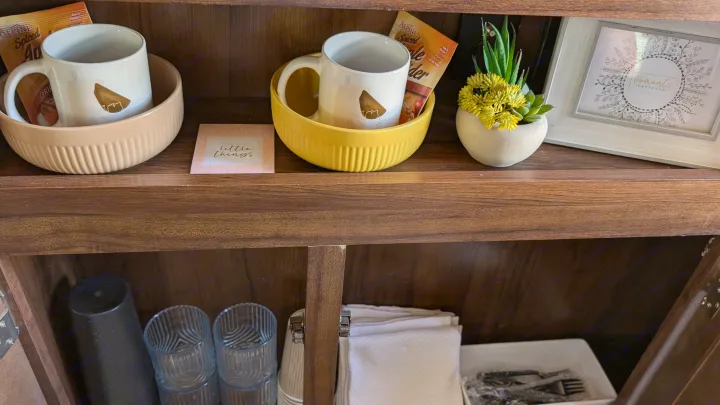 RV rental amenities: Mugs, spiced cider, thoughtful decor, and kitchen essentials neatly arranged for your stay.. Heartland RVs Mallard 2019