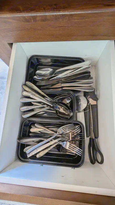RV rental kitchen drawer with organized cutlery & tools. Compact storage for travel convenience.. Heartland RVs Mallard 2019