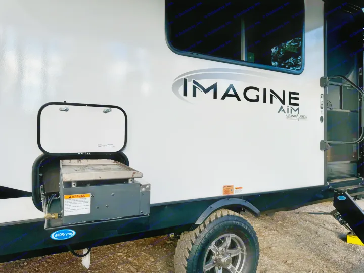 Side view of an Imagine Aim RV rental, showcasing its outdoor griddle. Great for road trips and camping.. Grand Design Imagine AIM 2024