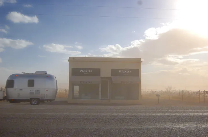 An RV rental, a silver Airstream, parked next to the famous Prada Marfa art installation in the Texas desert.. Airstream Sport 2018