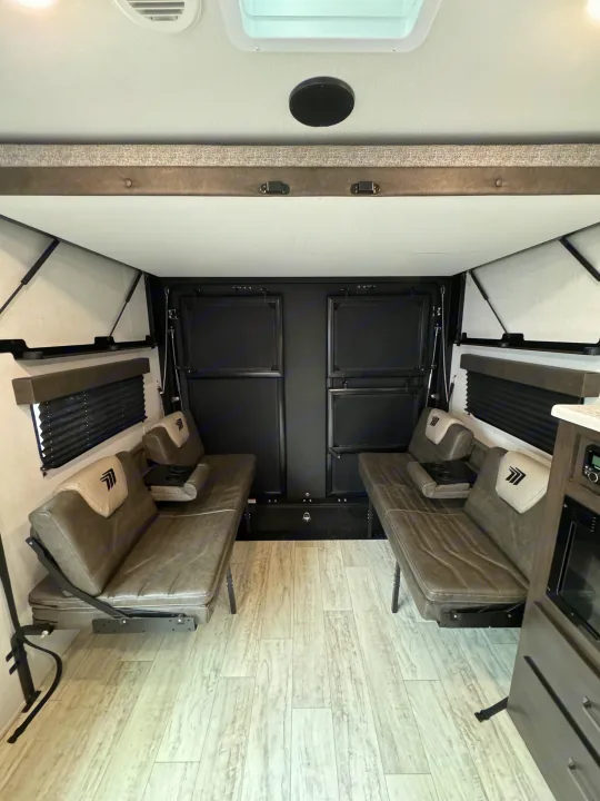 Versatile RV rental interior with fold-down sofas, ideal for seating, sleeping, or cargo. Light floors & modern design.. Grand Design Grand Design Trailer 2024