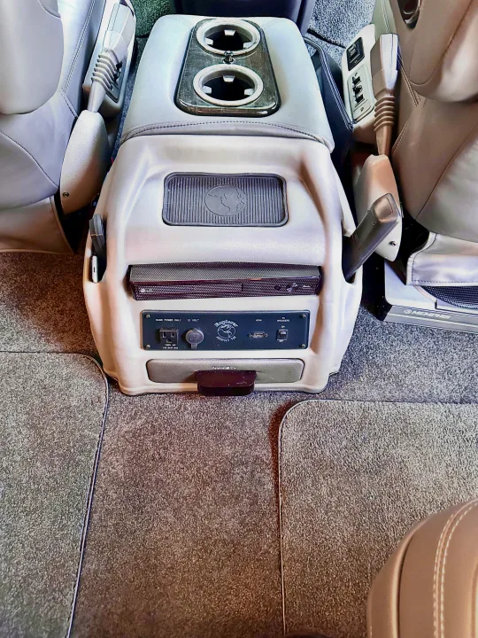 Inside an **rv rental**: comfort console with cup holders, power outlets, LG media, Apple TV, and adjustable seating.. CHEVROLET Cargo Van 2020