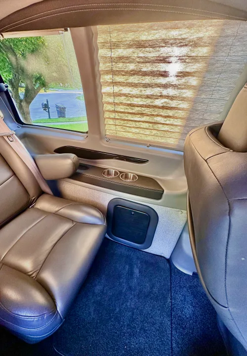 Spacious RV rental interior with comfortable leather seating, window shades, and handy cup holders.. CHEVROLET Cargo Van 2020