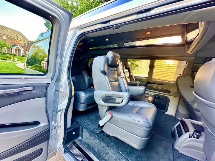 Step into luxury: this spacious RV rental interior features plush leather captain's chairs, entertainment, and skylights.. CHEVROLET Cargo Van 2020