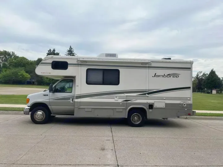 This white & gray Fleetwood Jamboree Class C motorhome, shown from the side, is available as an RV rental.. Jamboree Jamboree Motorhome 2004