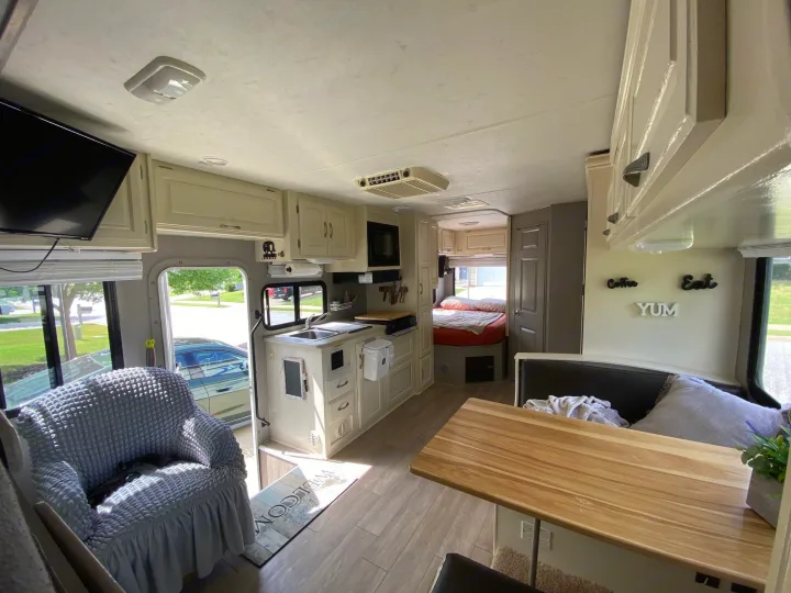 Bright, modern RV rental interior featuring a full kitchen, dining area, comfy seating, and bedroom. Ready for adventures.. Four Winds 5000 2008
