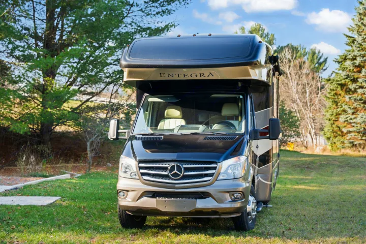 Entegra Coach RV rental on a Mercedes-Benz Sprinter chassis, parked on green grass, ready for your next adventure.. Entegra Coach Qwest 2018