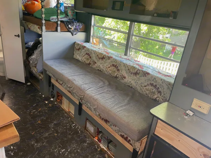 RV rental interior: bunk beds, bench seating, and large windows with yard view.. Sunline T2251 1985