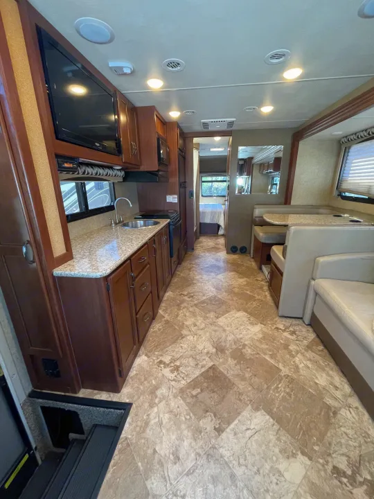 This RV rental offers a well-appointed kitchen, comfortable dining area, and a private bedroom, all within a spacious interior.. Thor Motor Coach A.C.E 2017