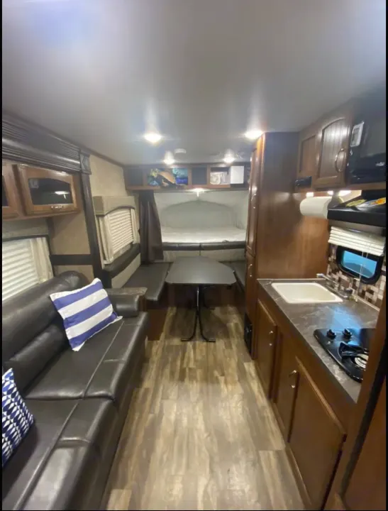 Full view of an RV rental interior: living area, kitchen, dinette, & pop-out bed. Ideal for your next trip.. Jayco Jay Feather 2017