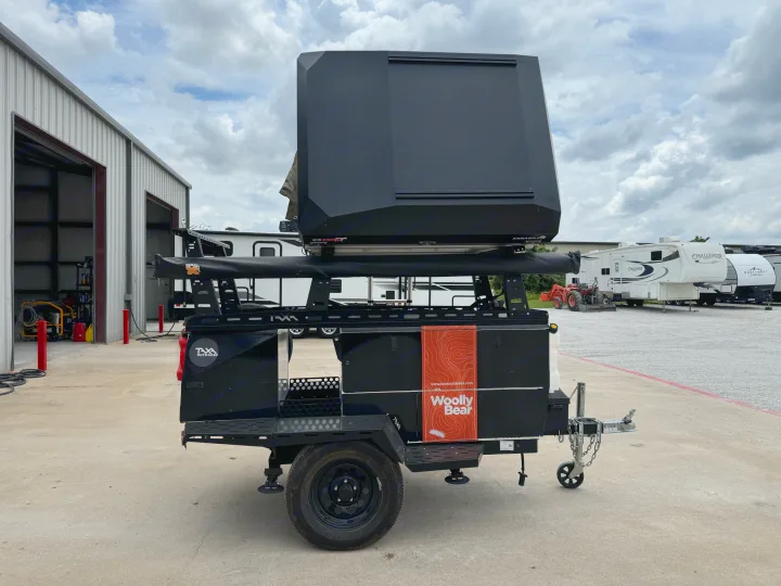 Black Taxa Outdoors Woolly Bear overland trailer with rooftop tent, ready for rv rental adventures.. taxa Woolly Bear 2017