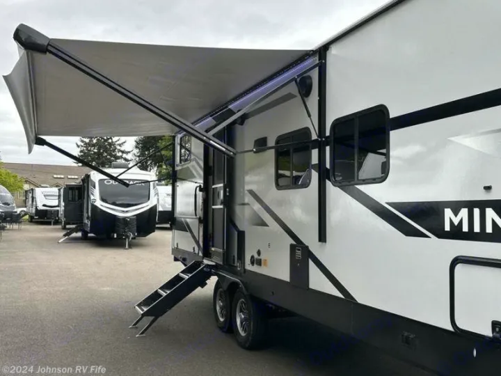 White travel trailer RV rental with an extended awning and entry steps. Ideal for outdoor adventures!. Winnebago Minnie 2301BHS 2024