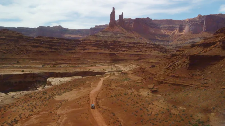 Experience adventure with an RV rental on a desert road, amidst towering red rock formations and a vast canyon landscape.. Toyota Tacoma - GoFastCamper 2007