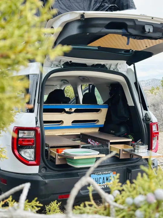 This custom car camping SUV, equipped with a pull-out tailgate kitchen, offers an agile alternative to an RV rental.. Ford Bronco Sport 2022