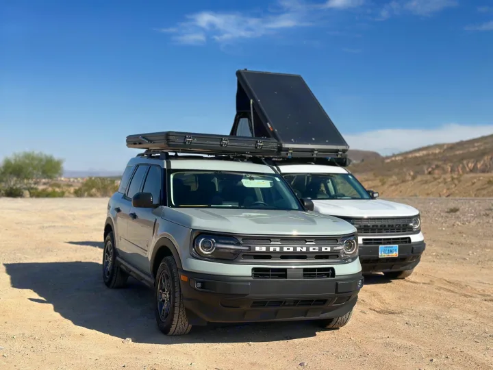 Two Ford Bronco Sport SUVs with rooftop tents, ready for your next rv rental camping adventure in the desert.. Ford Bronco Sport 2022