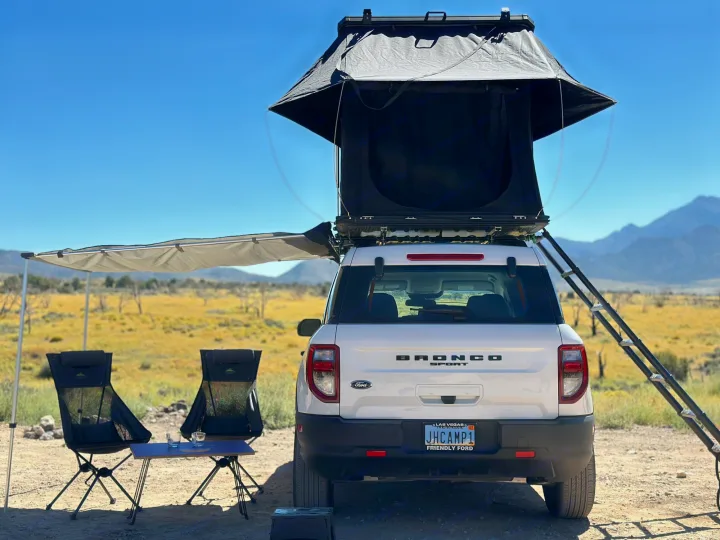 White Ford Bronco Sport with rooftop tent & awning set up for camping. An RV rental alternative for desert overlanding.. Ford Bronco Sport 2022