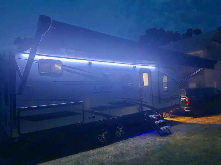 Illuminated rv rental travel trailer at night, with a bright LED awning and glowing interior. Ready for your adventure!. Cruiser RV MPG 2500bh 2024