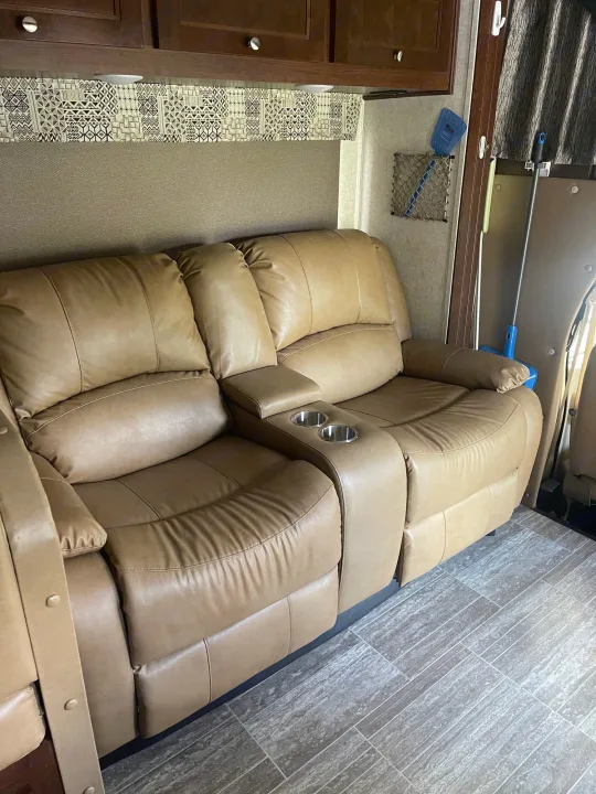 RV rental interior: Comfortable tan leather recliners with cup holders, tiled floor, and overhead cabinets.. Forest River Sunseeker 2018