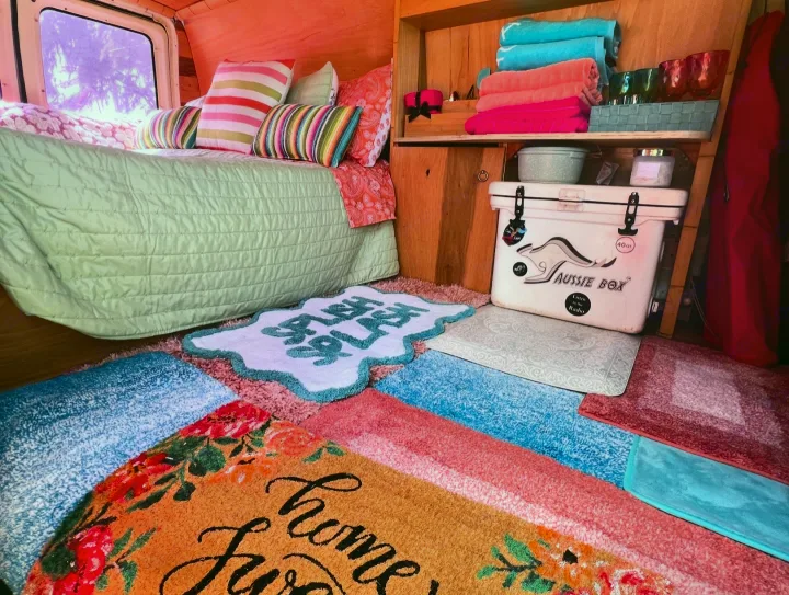 Step into this colorful RV rental: a plush bed, "Aussie Box" cooler, and playful floor mats make for a cozy journey.. Ford E250 Eagle Camper 2006
