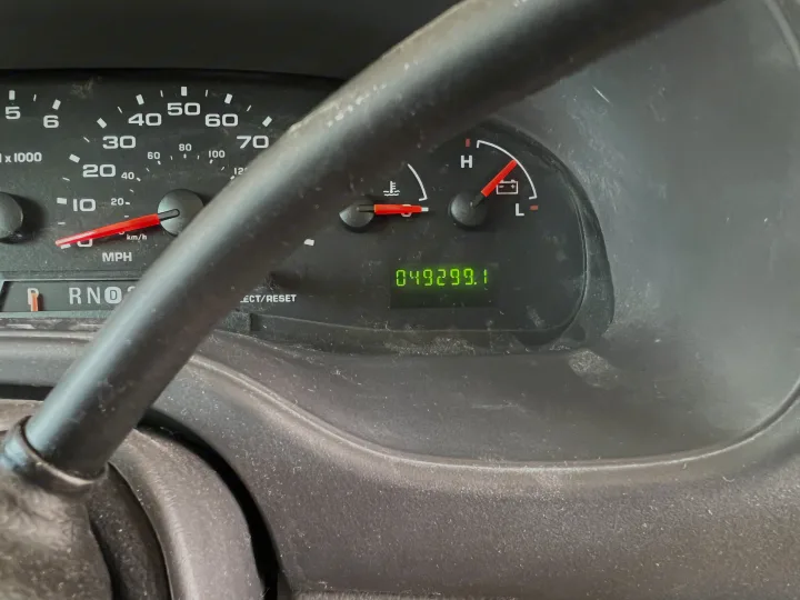 Dusty RV rental dashboard. Odometer reads 49,299.1 miles, with speedometer, temperature, and battery gauges.. Coachmen Freelander 2007
