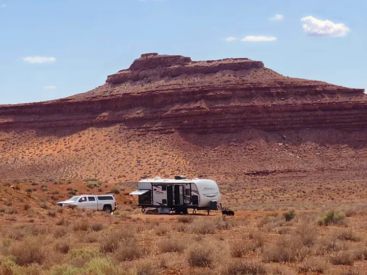 This RV rental is perfectly set up for a desert adventure, parked with a truck against a stunning mesa backdrop.. KZ Spree 301RIK 2015