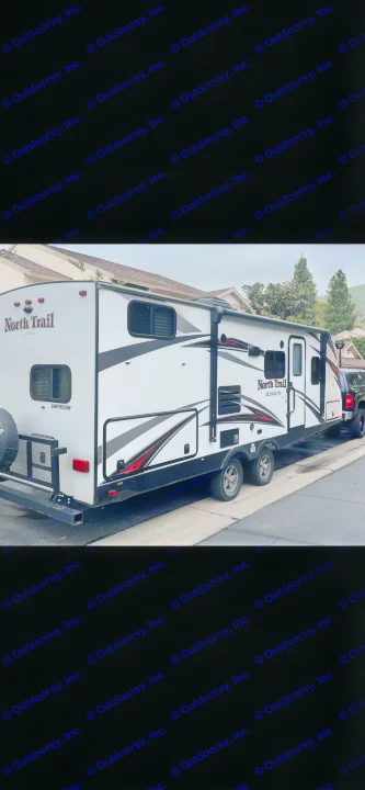 This white North Trail travel trailer is available for rv rental. A spacious camper parked and ready for your next road trip adventure.. Heartland RVs North Trail 2019