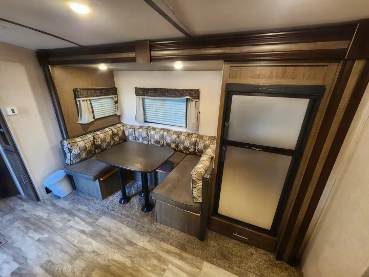 Step into this RV rental! Features include a U-shaped dinette with patterned cushions, square table, and Dometic refrigerator.. Forest River Surveyor Legend 2019