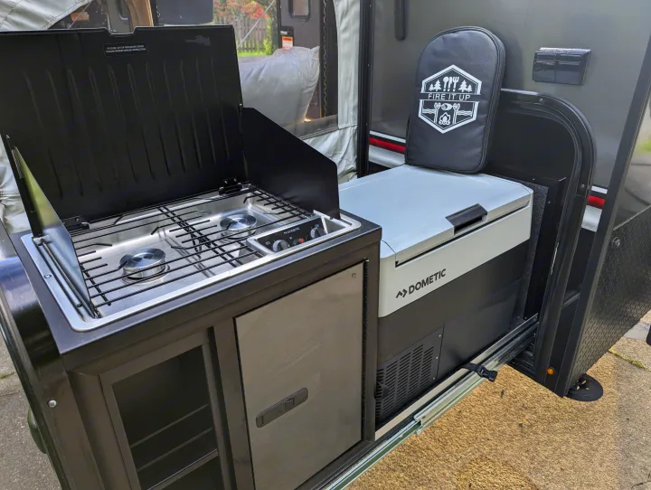 This rv rental features a pull-out outdoor kitchen with a Dometic fridge, two-burner camping stove, and storage.. Intech Flyer Explore 2022