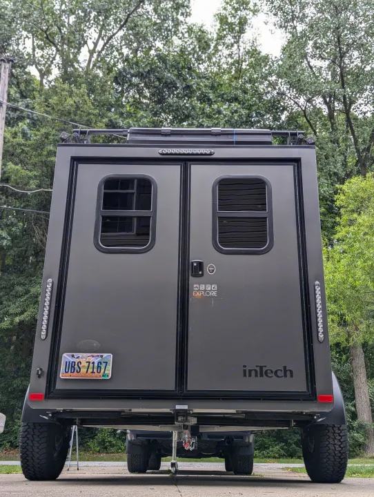 Rear of an inTech Explore adventure trailer, ideal for rv rental. Visible are twin doors, windows, and an Ohio license plate.. Intech Flyer Explore 2022