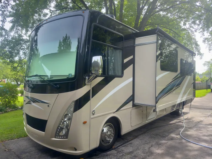Experience comfort with this beige Class A motorhome RV rental, featuring an extended slide-out for more space.. Thor Windsport 2020