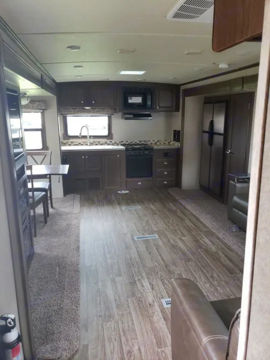 RV rental interior showing a well-equipped kitchen, dining table, and cozy living space.. Forest River Flagstaff Classic 2019
