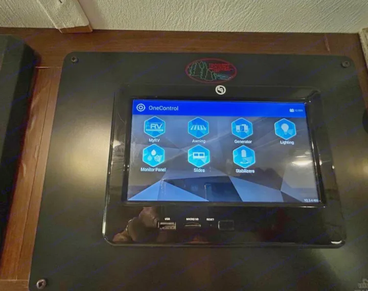 RV rental smart control panel: a digital screen managing awning, generator, slides, and lighting. USB/SD ports visible.. Forest River Mercedes 2019