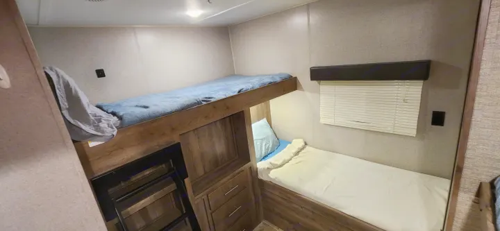 RV rental bunk bedroom: a cozy space with multiple beds and built-in storage, perfect for family adventures.. Aspen Trail Aspen Trail Trailer 2019