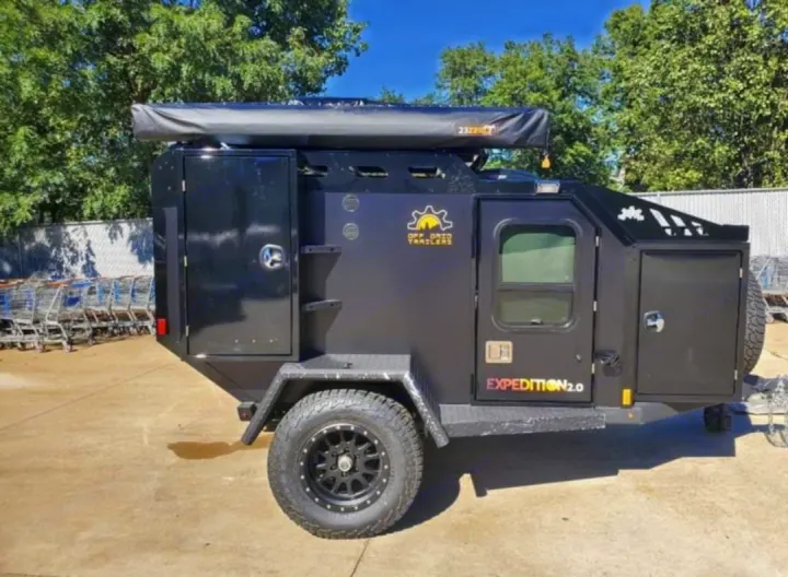 This black Off Grid Trailers Expedition 2.0, a rugged off-road camper with an awning, perfect for an RV rental.. Off Grid Trailers Off Grid Trailers Trailer 2021
