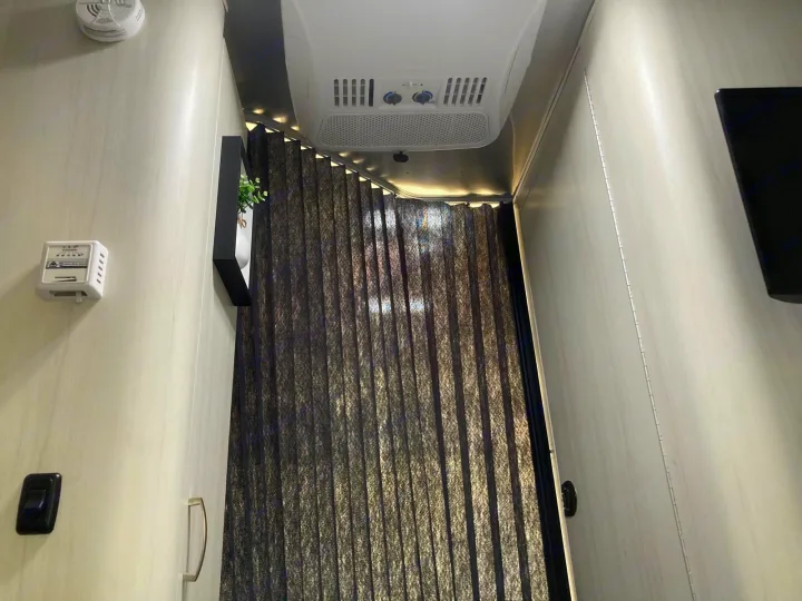 RV rental interior: ceiling AC, modern LED strip lighting, and blackout blinds for comfort and privacy.. Airstream Sport 2017