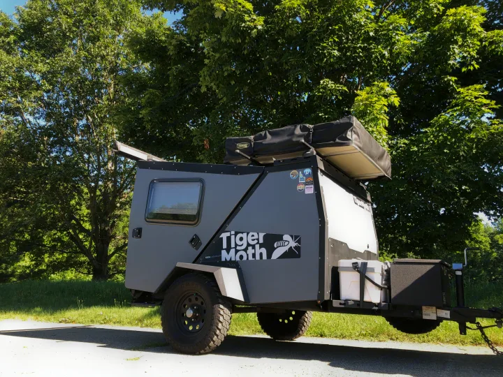 A rugged Taxa Tiger Moth off-road camping rv rental trailer with a rooftop tent, ready for adventure.. TAXA TAXA Trailer 2019