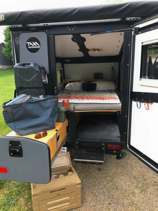 Inside this TAXA Outdoors rv rental: a cozy bed, ample storage, and organized outdoor gear for adventure.. TAXA TAXA Trailer 2019