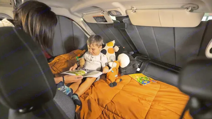 Mom reads to her son in a cozy RV rental setup, perfect for family camping and travel adventures.. Winnebago Solis 2021